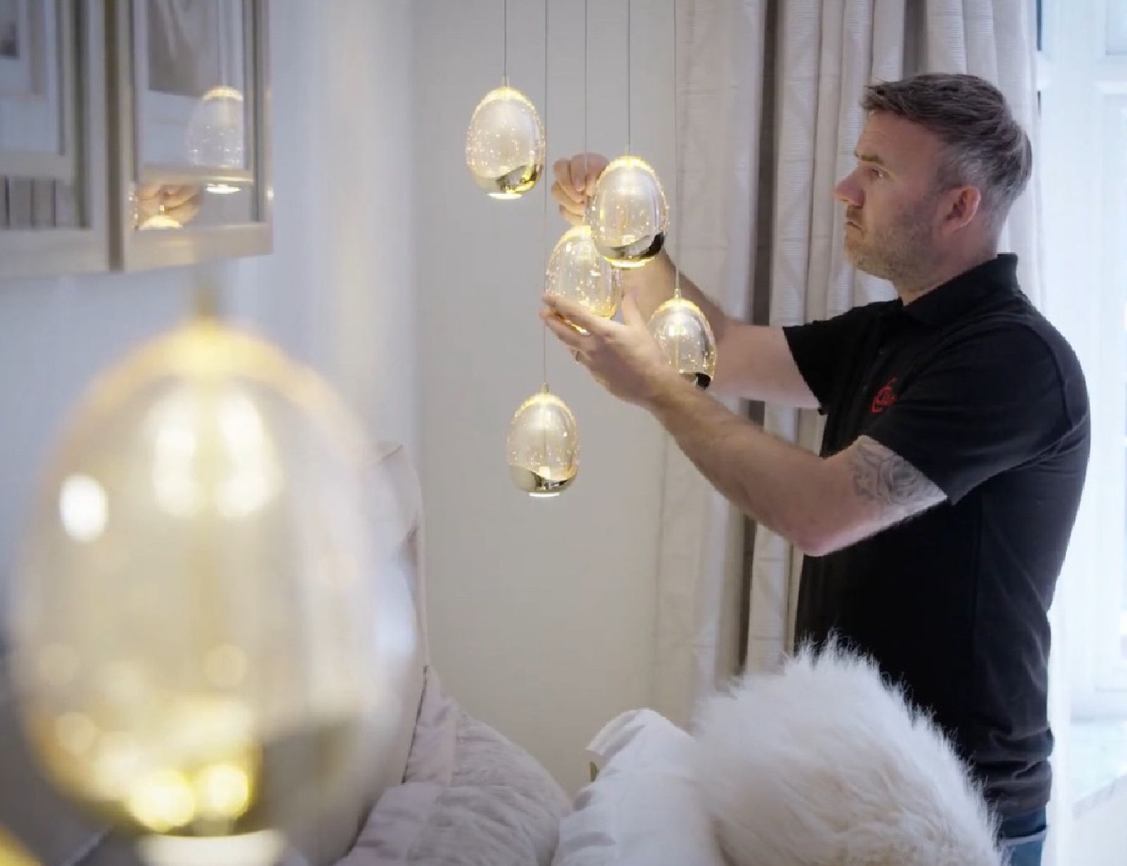 Chris Thompson, Managing Director at CTE Electrical Contractors, fitting ornate lighting at a Yorkshire residence.