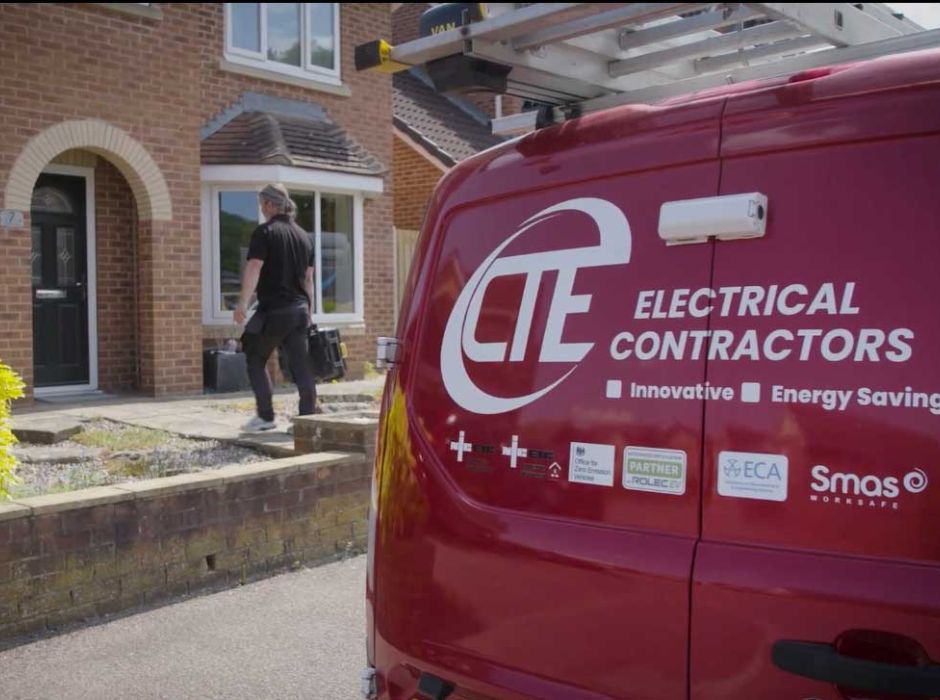 One of the CTE Electrical Contractors team arriving at a residential property with the rear of a CTE van in the foreground.