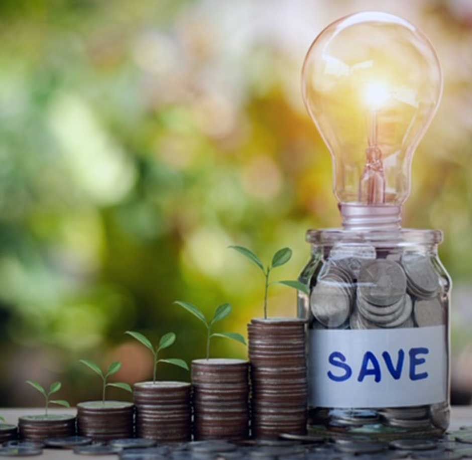 The benefits of an energy saving project illustrated by increasing piles of coins next to each other with plants growing from them and at the very end a glass jar full of coins and a lit lightbulb on top. There is a label on the jar marked SAVE