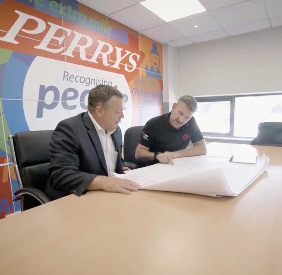 Chris Thompson - Managing Director at CTE Electrical Contractors - discussing an energy saving project with a business owner in Rotherham
