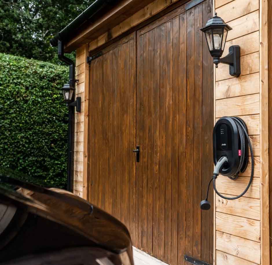 A home EV Charging point installed on a garage exterior wall by CTE Electrical Contractors in Barnsley, South Yorkshire