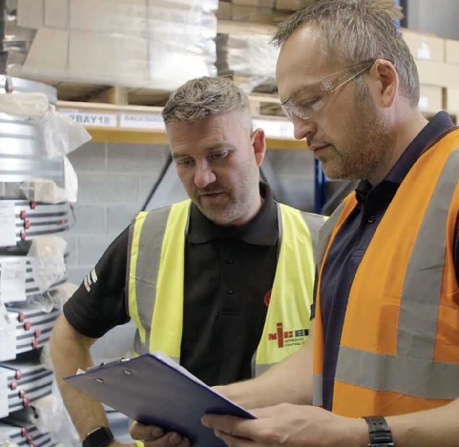 Chris Thompson - Managing Director at CTE Electrical Contractors - going through an energy-saving project plan with the owner of a busy warehouse in Wakefield