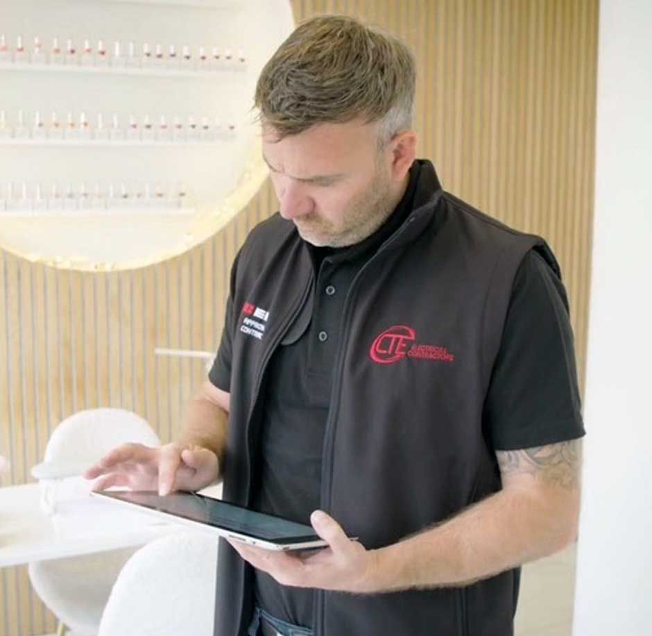 Chris Thompson - Managing Director at CTE Electrical Contractors - going through a wiring plan for energy saving led lighting at a beauty salon in Bradford
